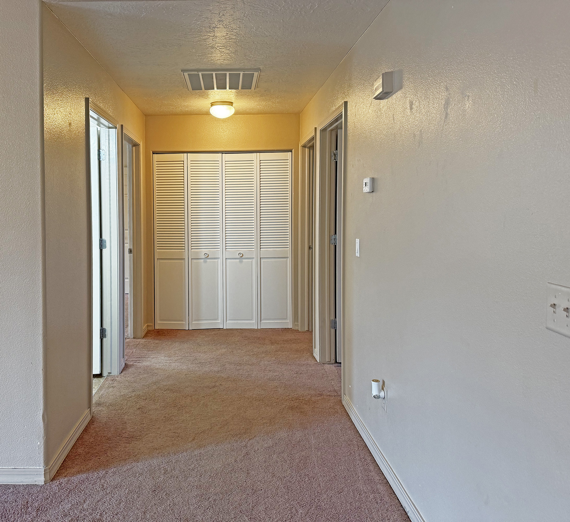 Hallway with laundry area straight ahead